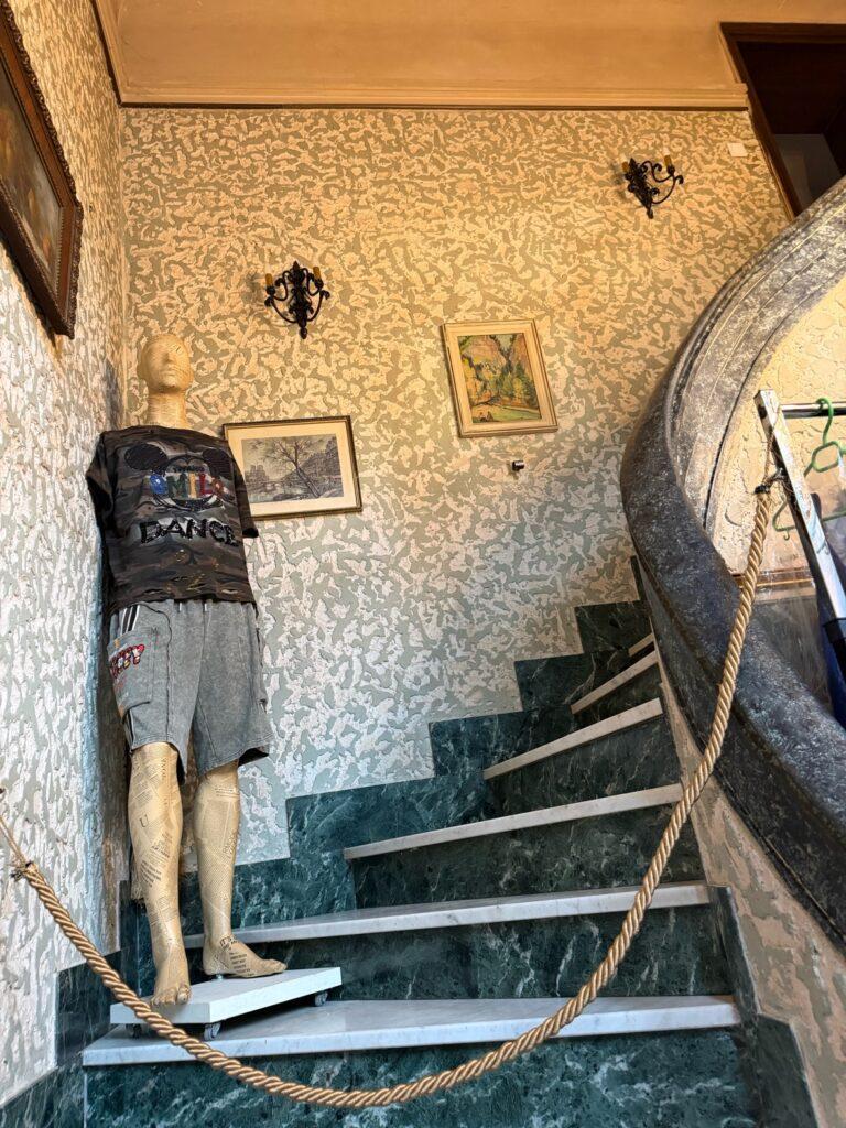 A mannequin in a room with a rope AI-generated content may be incorrect.