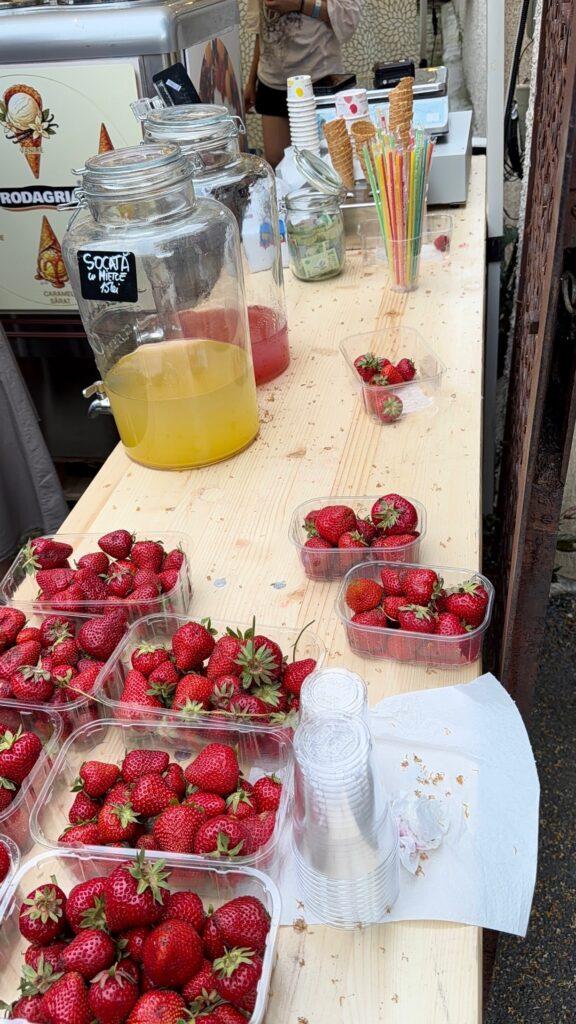 A table with strawberries and a drink dispenser AI-generated content may be incorrect.
